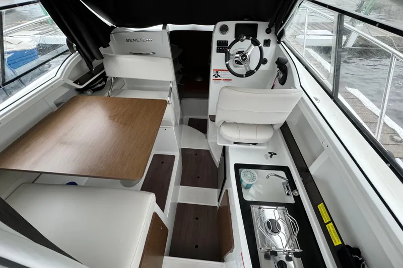 Slide: The Image of Interior of 2020 Beneteau Antares 8 boat with helm, seating, and kitchenette. - 15