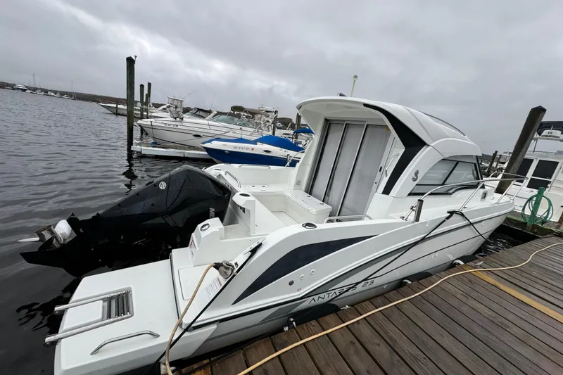 Slide: The Image of 2020 Beneteau Antares 8 docked at marina on a cloudy day. - 7