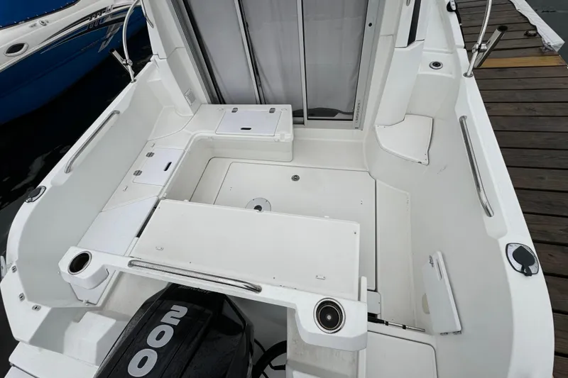Slide: The Image of 2020 Beneteau Antares 8 boat cockpit with seating and storage, docked at marina. - 8