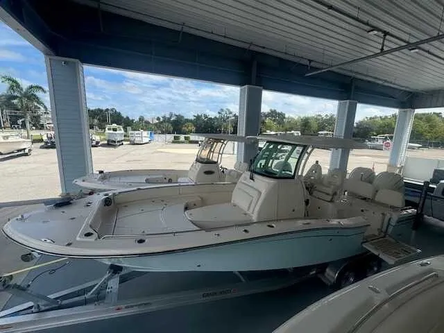 Slide: The Image of 2026 Grady-White 281 Coastal Explorer boat on trailer, showcasing spacious deck and seating. - 2