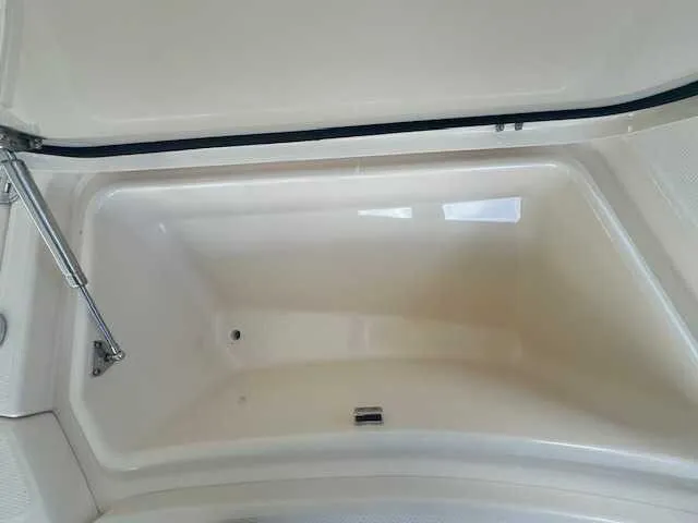 Slide: The Image of 2026 Grady-White 281 Coastal Explorer boat on trailer, parked near palm trees. - 22