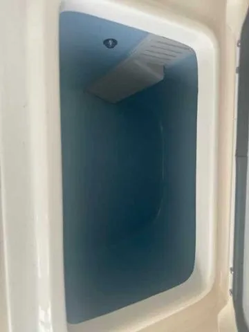 Slide: The Image of 2026 Grady-White 281 Coastal Explorer boat interior with seating and speakers, displayed outdoors. - 39