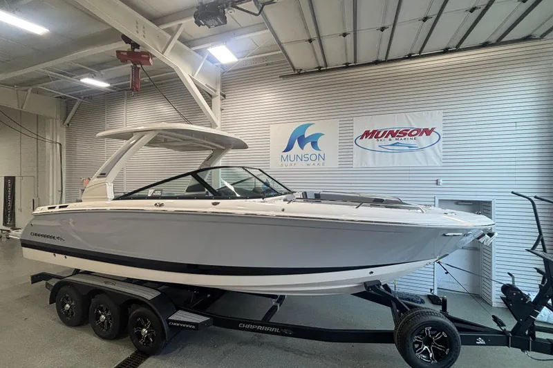 The Image of 2026 Chaparral SSX 30 boat on trailer in showroom, Munson Ski & Marine signage. - 0