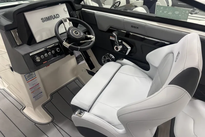 Slide: The Image of 2026 Chaparral SSX 30 boat cockpit with Simrad display and luxurious white seating. - 10