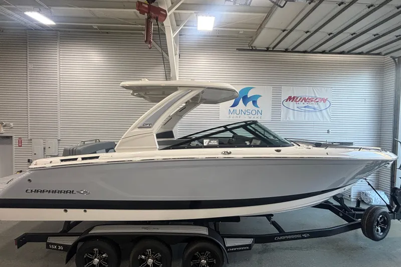 Slide: The Image of 2026 Chaparral SSX 30 boat in showroom, displayed on a trailer. - 5