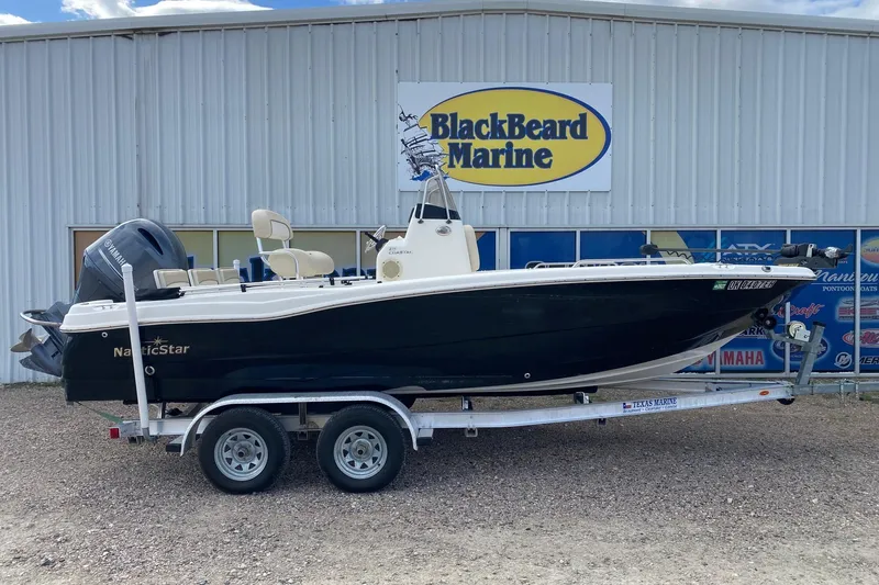 The Image of 2018 NauticStar 211 Coastal boat on trailer at BlackBeard Marine dealership. - 1