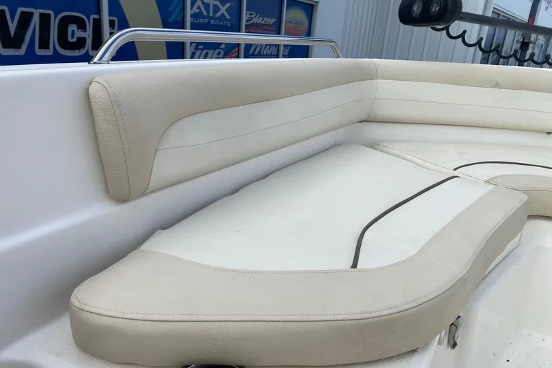 Slide: The Image of 2018 NauticStar 211 Coastal boat with beige cushioned seating. - 12