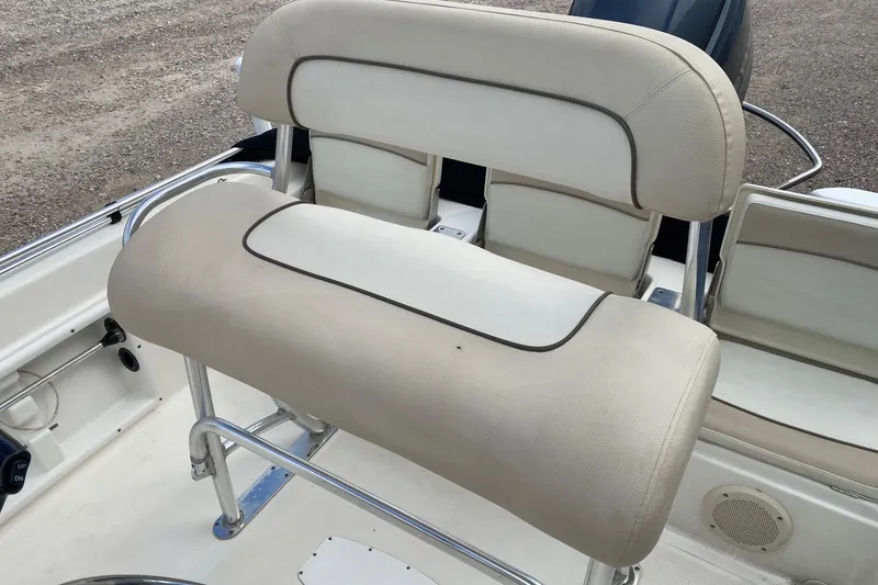 Slide: The Image of 2018 NauticStar 211 Coastal boat seating with beige upholstery and stainless steel frame. - 14