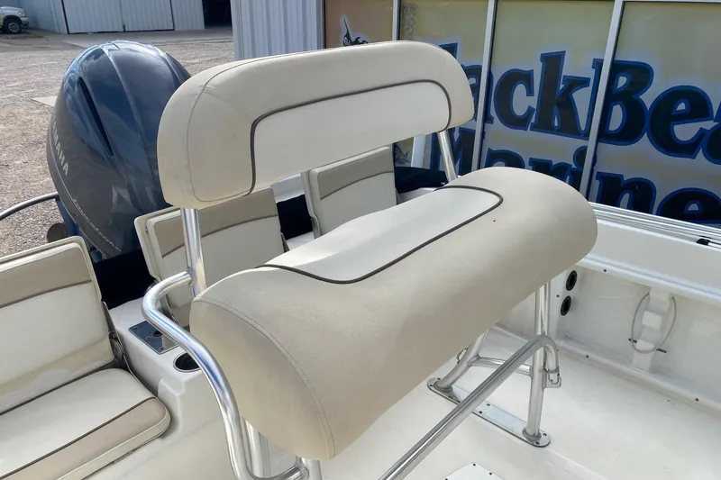 Slide: The Image of 2018 NauticStar 211 Coastal boat interior with cushioned seating and Yamaha engine. - 9
