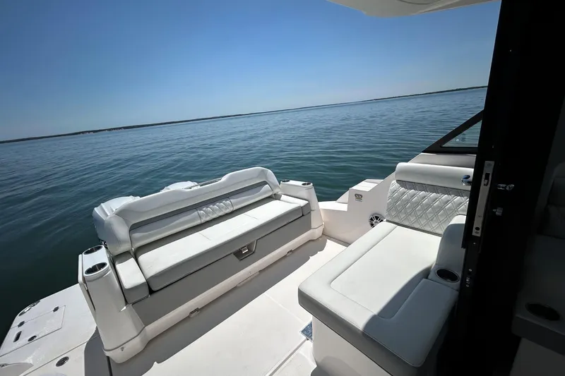 Slide: The Image of Luxurious seating on the 2025 Regal 36 XO boat, overlooking serene waters. - 10