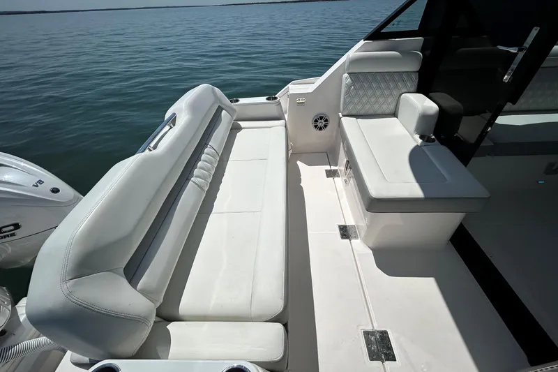 Slide: The Image of 2025 Regal 36 XO boat interior with white seating and ocean view. - 14