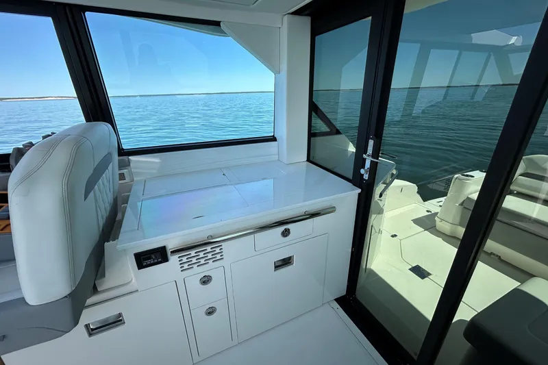 Slide: The Image of Interior view of 2025 Regal 36 XO yacht with sleek design and ocean backdrop. - 19