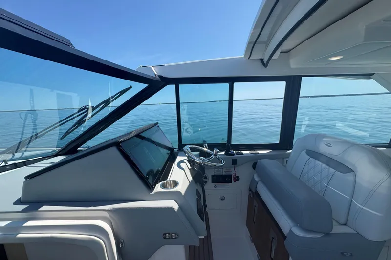 Slide: The Image of Interior view of 2025 Regal 36 XO yacht cockpit with modern steering and seating. - 22