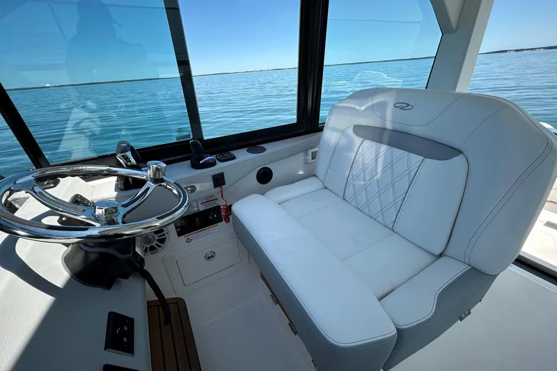 Slide: The Image of Luxury helm seat and steering wheel on 2025 Regal 36 XO boat. - 25