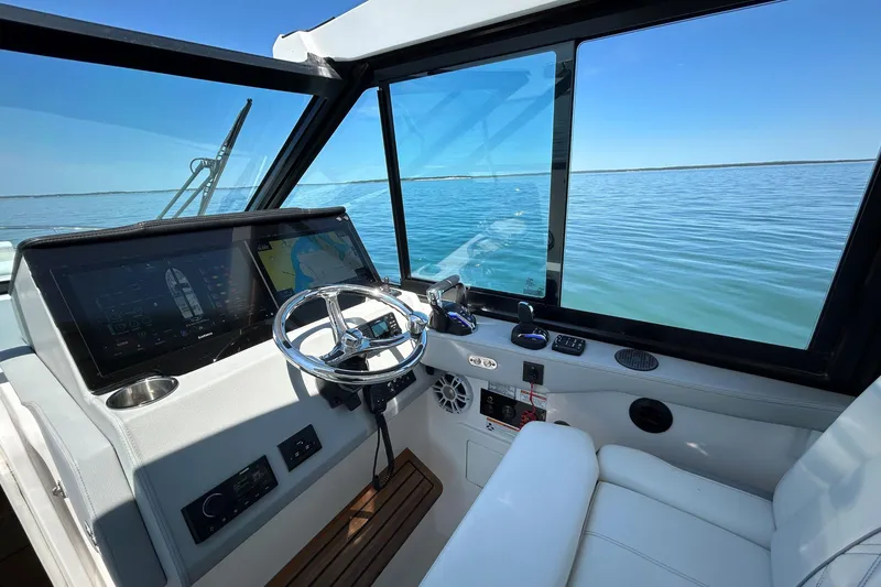 Slide: The Image of 2025 Regal 36 XO boat cockpit with modern controls and ocean view. - 26