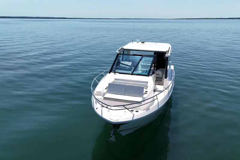 Slide: The Image of 2025 Regal 36 XO boat on calm water, showcasing sleek design and modern features. - 3