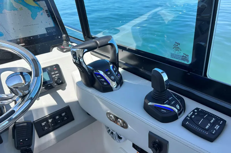 Slide: The Image of Control panel of 2025 Regal 36 XO boat with steering wheel and navigation equipment. - 30