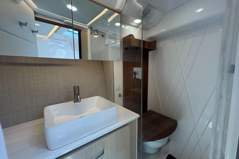 Slide: The Image of Modern bathroom in 2025 Regal 36 XO yacht with sleek sink and wooden accents. - 35