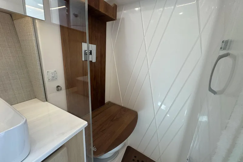 Slide: The Image of Modern bathroom interior of 2025 Regal 36 XO yacht with wood accents and sleek design. - 36