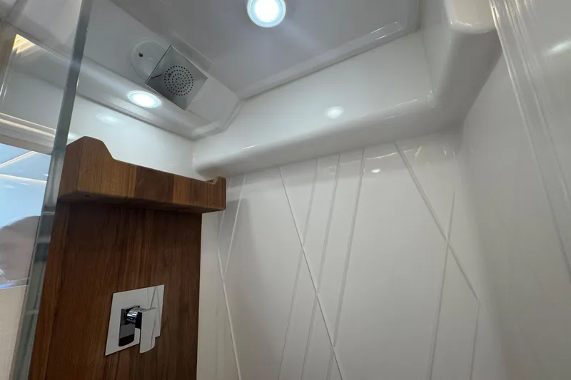 Slide: The Image of Modern shower interior in 2025 Regal 36 XO yacht, featuring sleek design and lighting. - 37