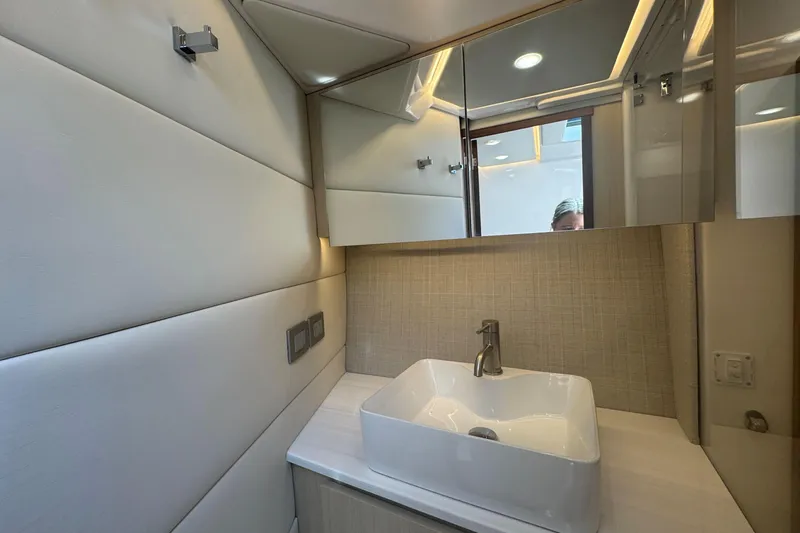 Slide: The Image of Luxurious bathroom interior of 2025 Regal 36 XO yacht with modern sink and mirror. - 38