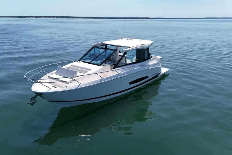 Slide: The Image of 2025 Regal 36 XO boat on calm water, showcasing sleek design and modern features. - 4