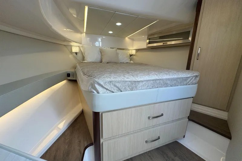 Slide: The Image of Luxurious cabin interior of 2025 Regal 36 XO yacht with modern bedding and storage. - 40
