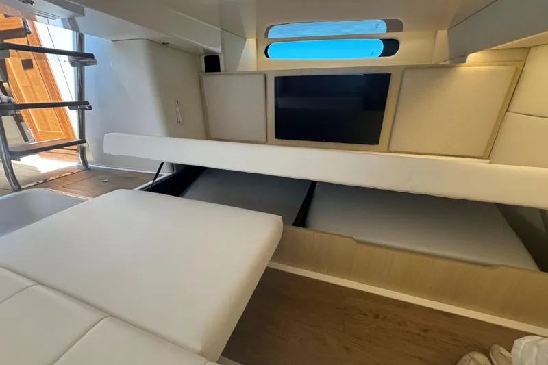 Slide: The Image of Luxurious interior of 2025 Regal 36 XO yacht with modern seating and TV. - 44