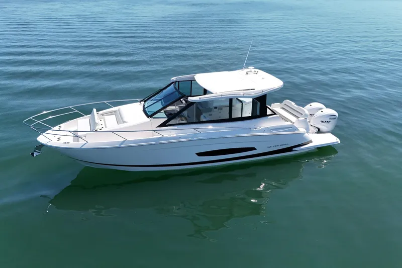 Slide: The Image of 2025 Regal 36 XO boat on calm water, side view. - 5