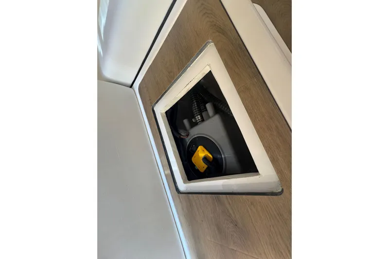 Slide: The Image of 2025 Regal 36 XO boat interior compartment with visible wiring and components. - 54