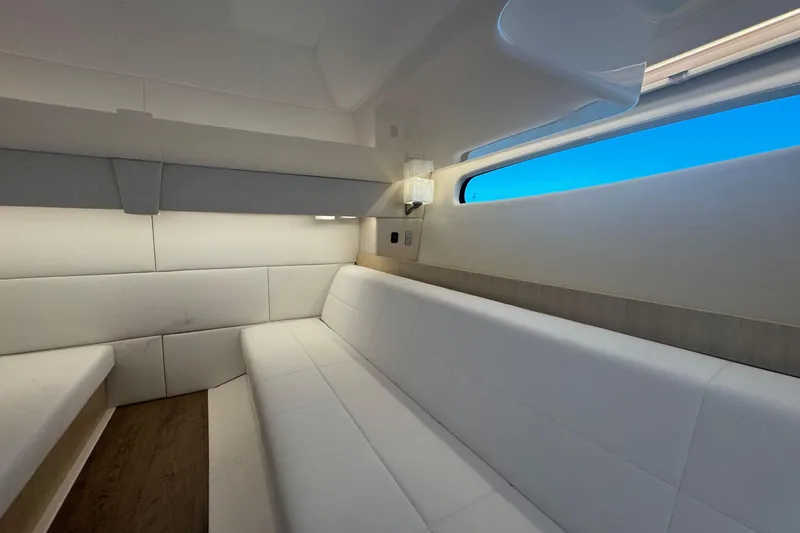 Slide: The Image of Luxurious interior of 2025 Regal 36 XO yacht with sleek white seating and modern design. - 56