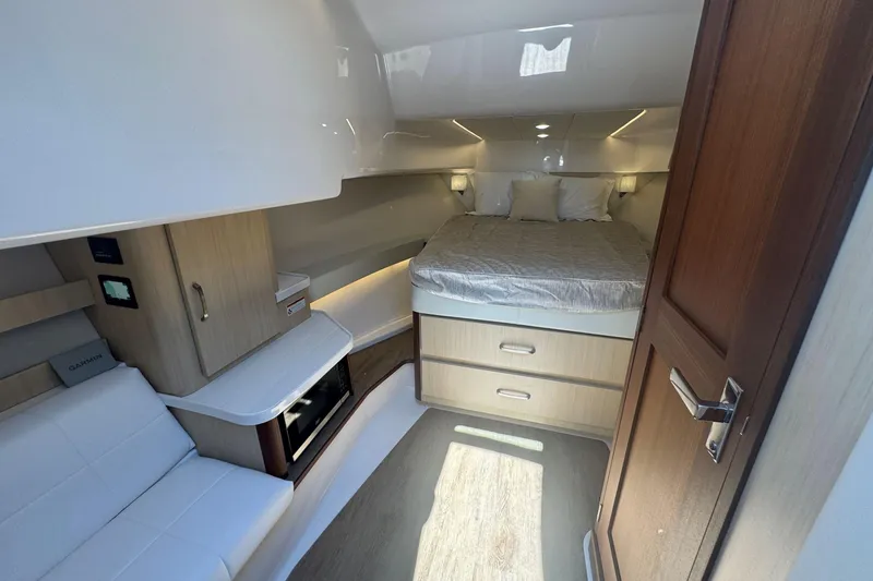 Slide: The Image of Luxurious interior of 2025 Regal 36 XO yacht with bed, seating, and storage. - 58