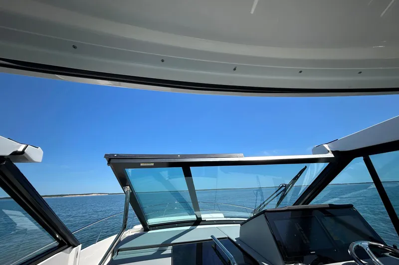 Slide: The Image of 2025 Regal 36 XO boat interior with ocean view and clear blue sky. - 59