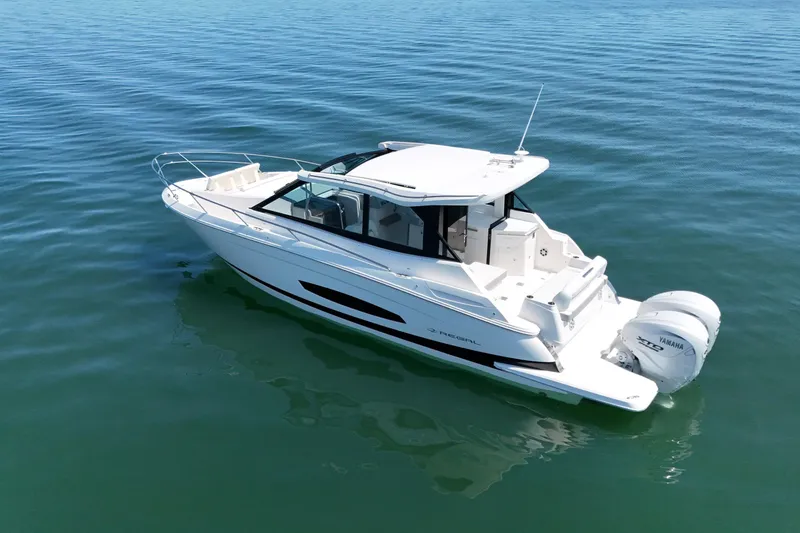 Slide: The Image of 2025 Regal 36 XO boat on calm water, featuring sleek design and twin Yamaha engines. - 6