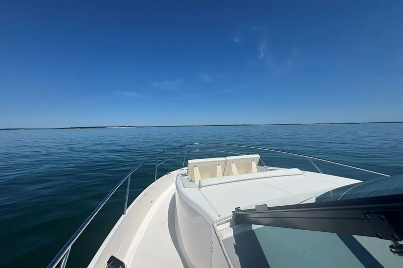 Slide: The Image of 2025 Regal 36 XO yacht cruising on calm blue waters under clear skies. - 61