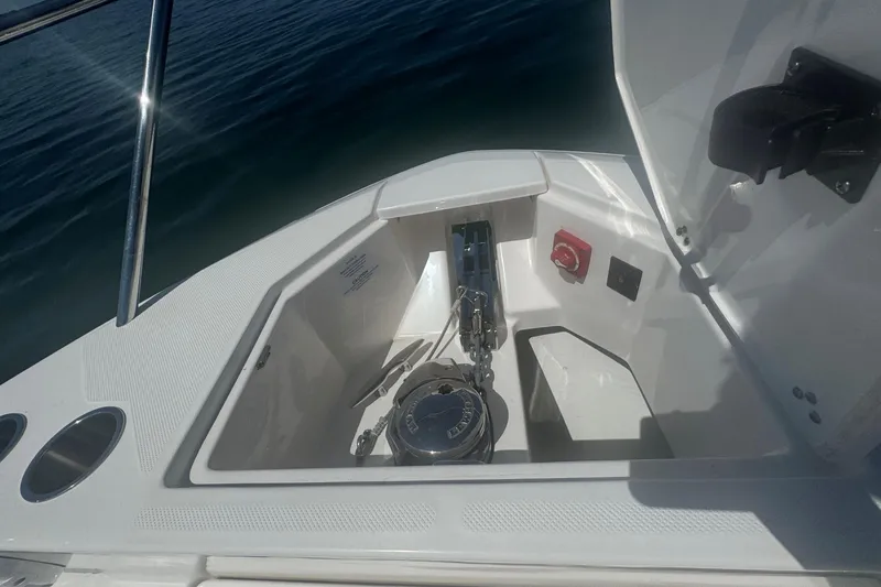 Slide: The Image of 2025 Regal 36 XO boat anchor compartment with chain and controls. - 63