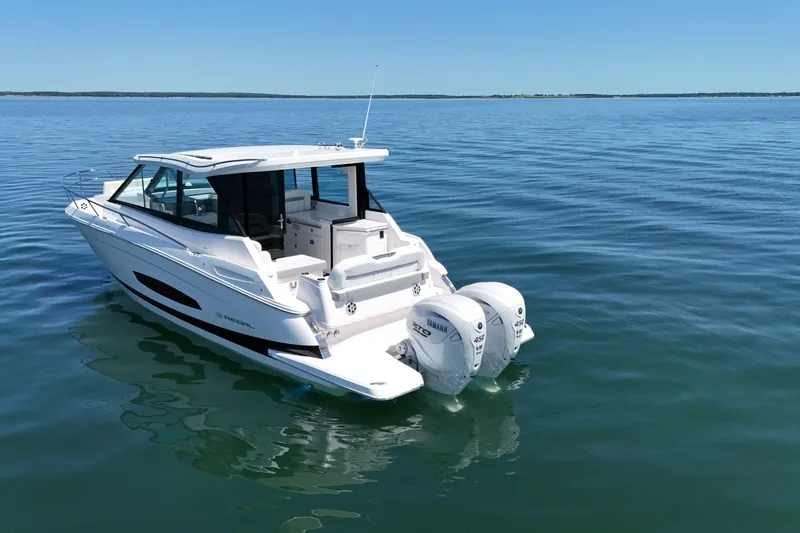 Slide: The Image of 2025 Regal 36 XO boat on calm water, featuring twin Yamaha outboard engines. - 7