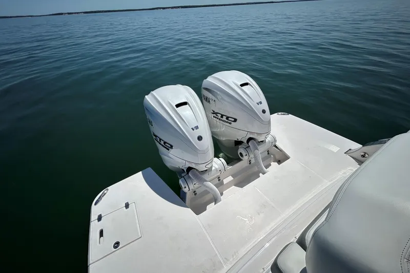 Slide: The Image of 2025 Regal 36 XO boat with twin Yamaha V8 outboard engines on calm water. - 9