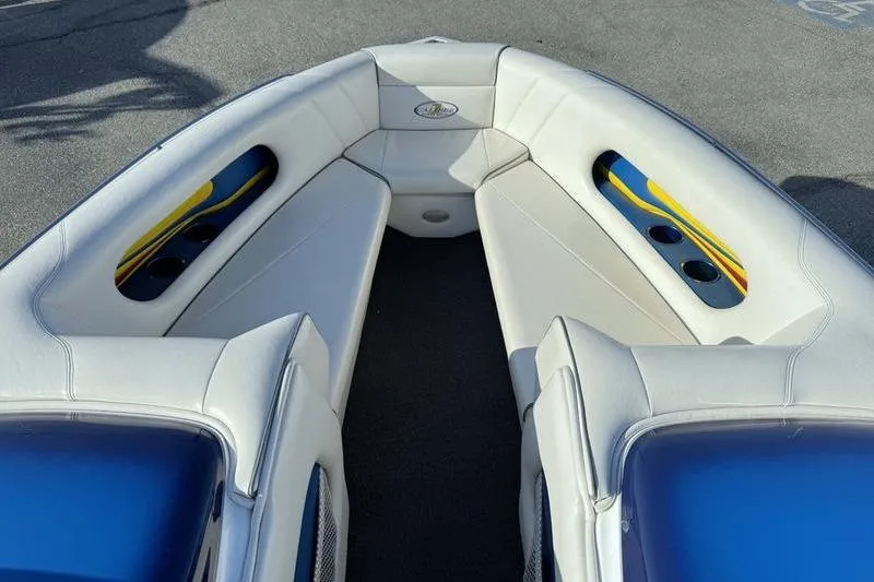 Slide: The Image of Interior view of 2013 Caliber 1 230 Velocity boat with white seating and blue accents. - 10