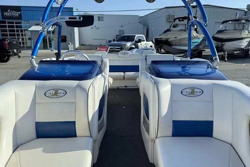 Slide: The Image of Interior view of a 2013 Caliber 1 230 Velocity boat with blue and white seating. - 13