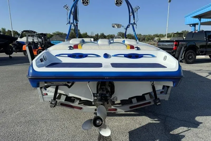 Slide: The Image of Rear view of 2013 Caliber 1 230 Velocity boat with blue accents and speakers. - 6