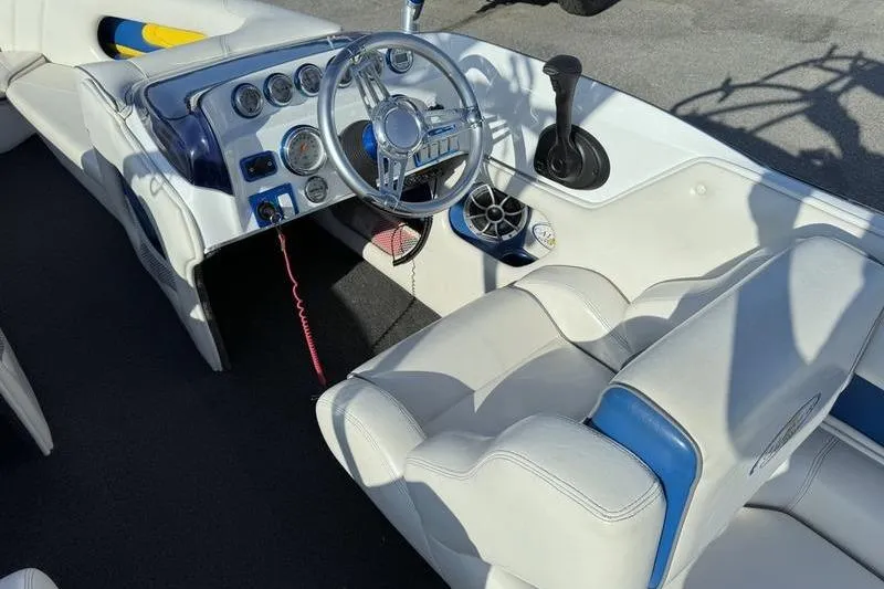 Slide: The Image of Interior of 2013 Caliber 1 230 Velocity boat with steering wheel and dashboard controls. - 9