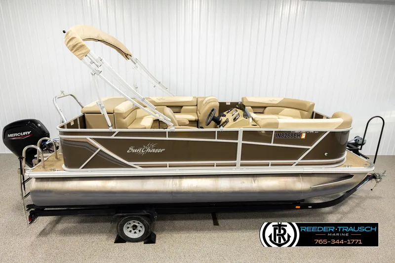 The Image of 2022 SunChaser 20 Geneva CRS pontoon boat with Mercury engine, displayed indoors. - 1