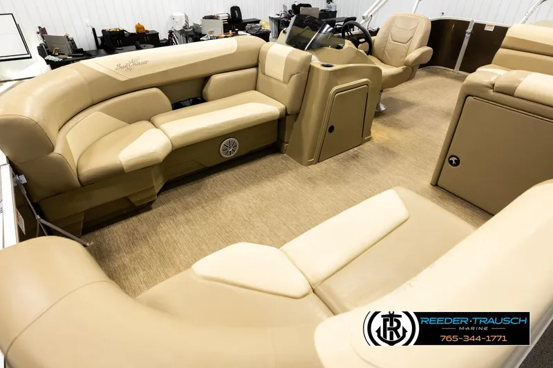 Slide: The Image of 2022 SunChaser 20 Geneva CRS pontoon boat interior with beige seating and steering console. - 10