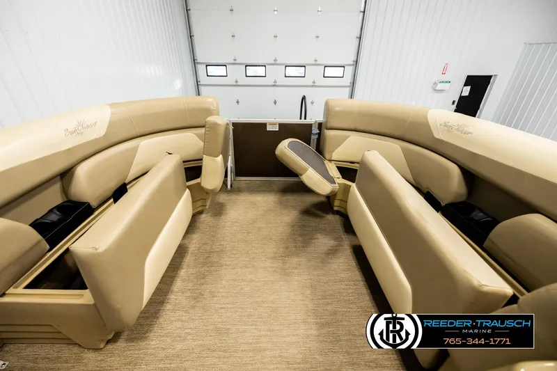 Slide: The Image of 2022 SunChaser 20 Geneva CRS pontoon boat interior with beige seating and storage compartments. - 18