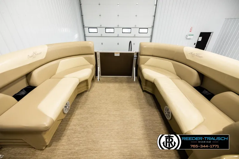 Slide: The Image of 2022 SunChaser 20 Geneva CRS pontoon boat interior with tan seating and carpeted floor. - 19