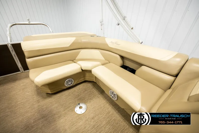 Slide: The Image of 2022 SunChaser 20 Geneva CRS boat interior with beige seating and marine speakers. - 20