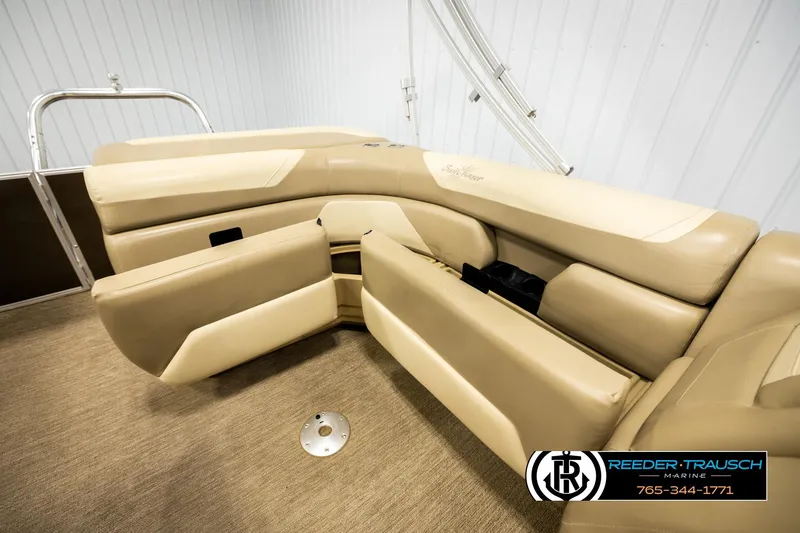 Slide: The Image of 2022 SunChaser 20 Geneva CRS boat interior with beige seating and carpeted floor. - 22