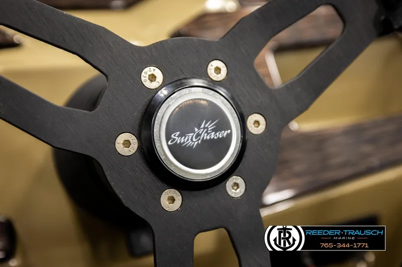 Slide: The Image of Steering wheel of 2022 SunChaser 20 Geneva CRS boat, featuring brand logo. - 28