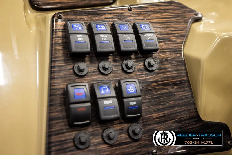 Slide: The Image of Control panel of 2022 SunChaser 20 Geneva CRS boat with various switches and buttons. - 29